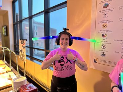 A person smile for the camera giving thumbs up. 