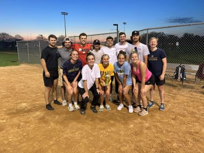 Intramural softball team poses with their trophy