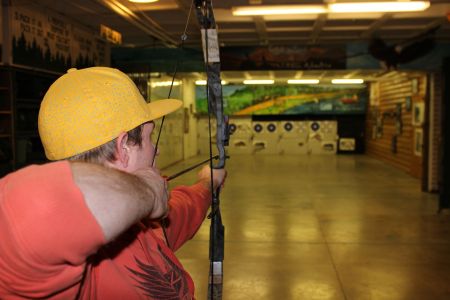 Archery range, man shooting bow at targets
