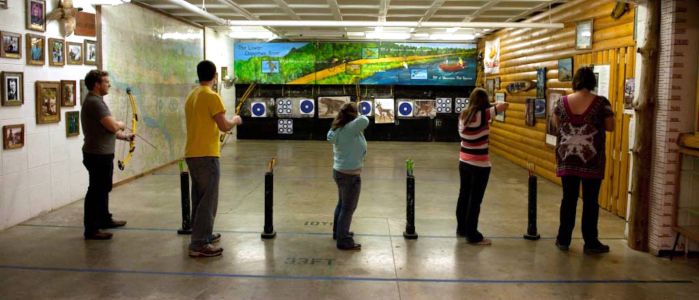 Four students using Hilltop Archery Range