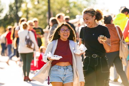 Students laugh and enjoy food at the annual UWEC Meets EC event.