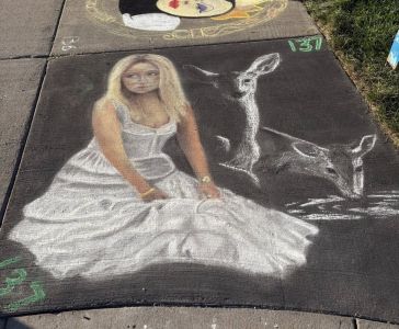 Chalk drawing of a girl in a white dress with deer- runner up of Chalkfest youth category