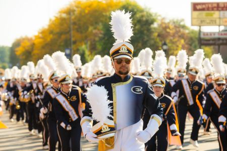 Blugold Marching Band members pose seriously before they start their performance during the Homecoming parade.