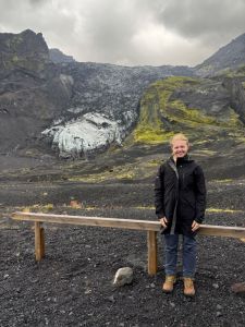UWEC student Elva Crist standing in winter gear in front of a mountain in Iceland