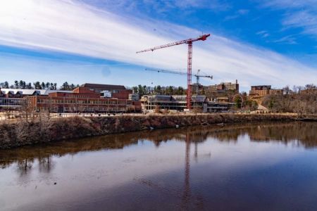 A chilly winter scene of the Chippewa River alongside construction of the Science and Health Sciences Building.