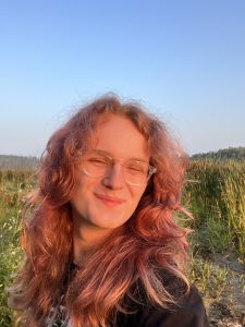 Headshot of Austyn Clemen in front of green hills and a blue sky