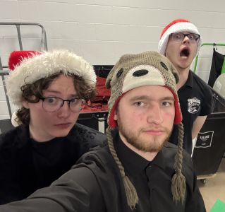 Jayson Coleman and two other UWEC students preparing for a winter holiday ensemble performance