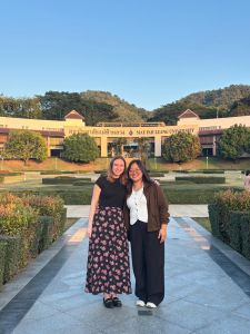 Schwartz and peer stand in front of MFU in Thailand