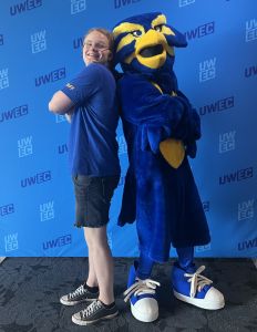 Austyn Clemen posing next to Blu the Blugold