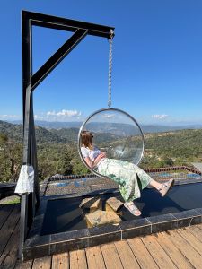 Carrie Schwartz lounges on a swing chair in Thailand