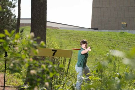 Student playing disc golf