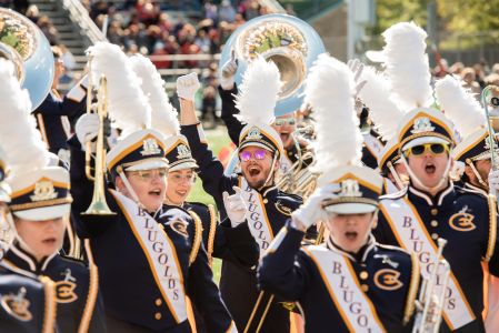 Blugold Marching Band members cheer at a football game