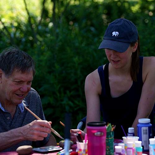 student working with aphasia patient at CSD garden 