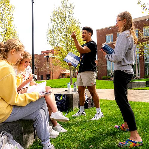 students outdoors for math class, laughing 