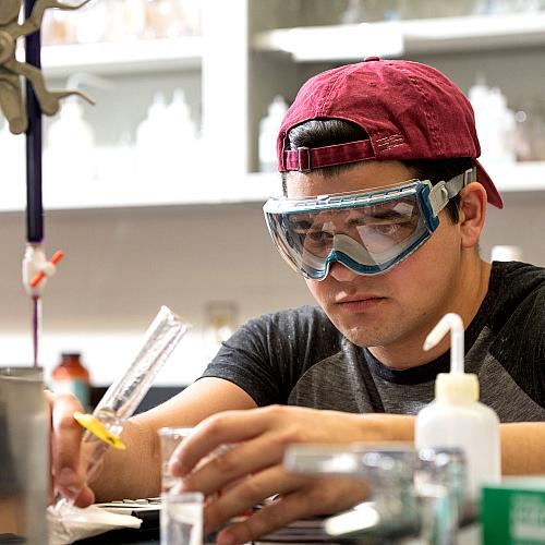 student in goggles in chem lab 