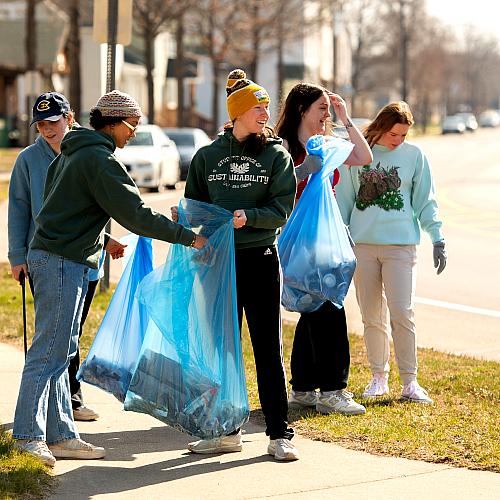 Students pick up trash around campus.