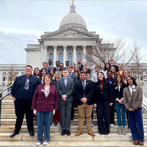 Student Senate stands outside a building at the Rally For Excellence.
