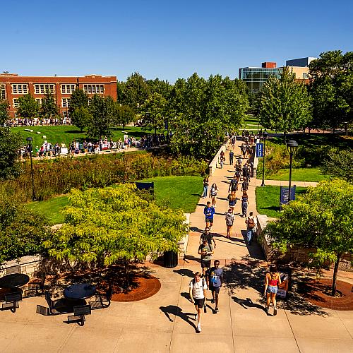 Students walking on campus on a sunny fall day